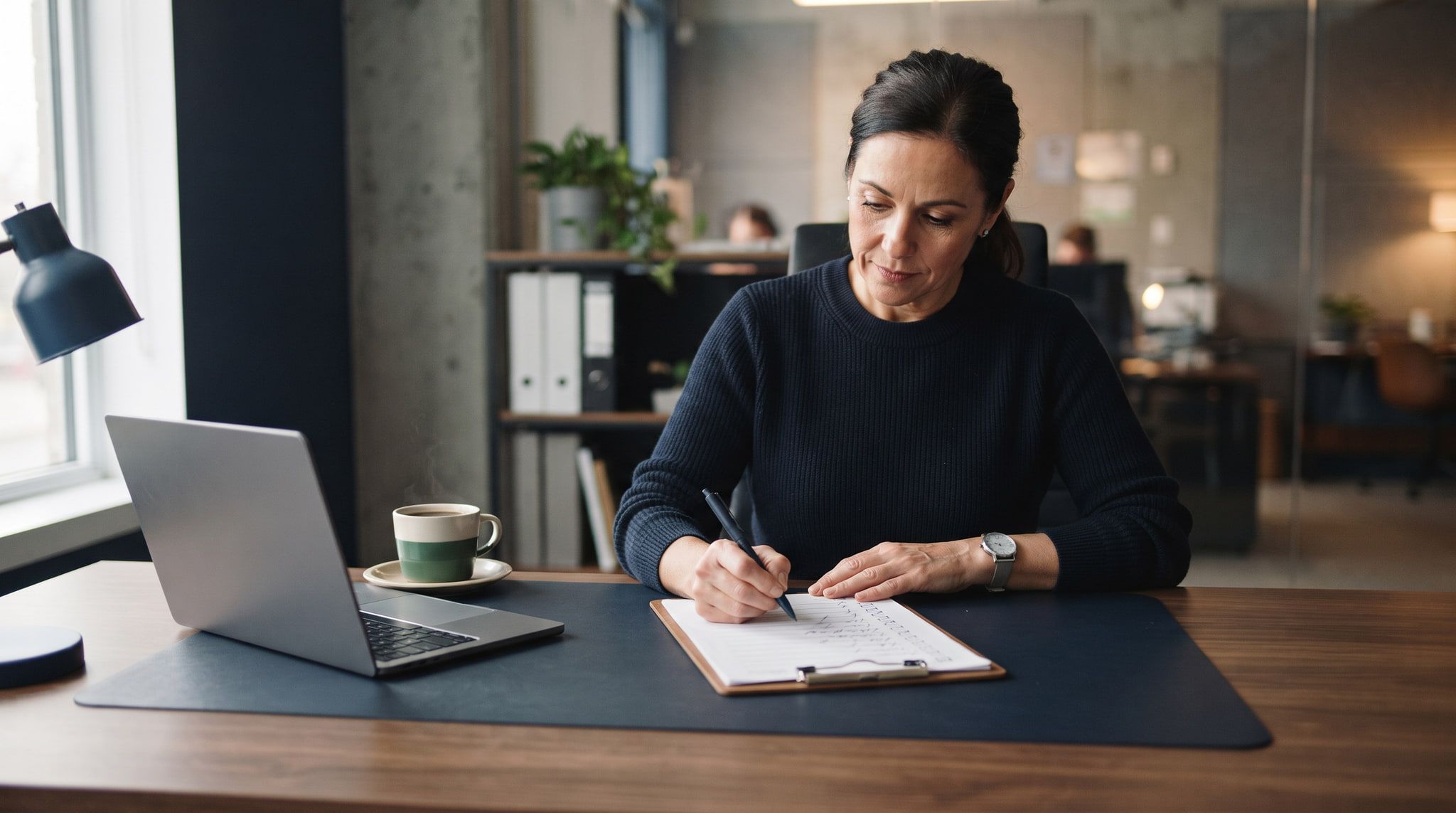 A small-business owner working through a printed checklist, several items already ticked.